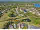 Aerial view of property in a verdant neighborhood with multiple ponds at 5616 Rockfield Loop, Valrico, FL 33596