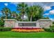 Stone-accented 'River Hills Golf and Country Club' entrance sign with colorful floral display at 5616 Rockfield Loop, Valrico, FL 33596