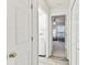 Hallway view featuring laundry area and bedroom at 5616 Rockfield Loop, Valrico, FL 33596