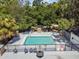 Aerial view of a community pool with lounge seating and lush landscaping at 5616 Rockfield Loop, Valrico, FL 33596