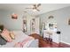 Cozy bedroom featuring a daybed, adjacent makeup vanity, a ceiling fan, and light-toned walls at 5627 Glencrest Blvd, Tampa, FL 33625