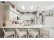 Bright kitchen features white cabinetry, stainless steel appliances, quartz countertops and a tiled backsplash at 5627 Glencrest Blvd, Tampa, FL 33625