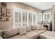 Living room with a large sectional sofa, shuttered windows, and neutral paint colors at 5627 Glencrest Blvd, Tampa, FL 33625