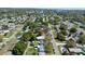 Low aerial view showcases the home and surrounding neighborhood, with mature trees at 619 41St Ne Ave, St Petersburg, FL 33703