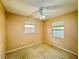 Small bedroom with tan walls, ceiling fan, and two windows providing natural light at 619 41St Ne Ave, St Petersburg, FL 33703