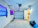 Spacious garage with gray door, lighting, and ample storage space at 619 41St Ne Ave, St Petersburg, FL 33703