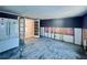 Open living room with french doors, a refrigerator, and exposed wall studs and insulation at 619 41St Ne Ave, St Petersburg, FL 33703