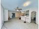 Open living area with ceiling fans, access to kitchen, and french doors to another room at 619 41St Ne Ave, St Petersburg, FL 33703