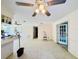 Open living area with textured walls, ceiling fan, and french doors to another room at 619 41St Ne Ave, St Petersburg, FL 33703