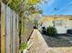 Side yard view with a wooden fence and pathway at 619 41St Ne Ave, St Petersburg, FL 33703