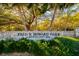 Entrance to Fred H. Howard Park with lush greenery and stone sign at 627 Kenneth Way, Tarpon Springs, FL 34689