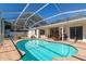 Sparkling in-ground pool surrounded by a spacious patio, ideal for outdoor living at 627 Kenneth Way, Tarpon Springs, FL 34689