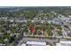 Overhead shot of a residential property in a tree-filled neighborhood, indicated by a red arrow at 7016 2Nd N St, St Petersburg, FL 33702