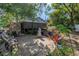 Relaxing backyard patio featuring brick pavers and mature tropical landscaping at 7016 2Nd N St, St Petersburg, FL 33702