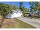 Exterior features an attached garage, driveway and a well-manicured lawn at 7016 2Nd N St, St Petersburg, FL 33702