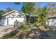 Inviting single-story home with a two-car garage and lush landscaping at 7016 2Nd N St, St Petersburg, FL 33702