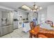 Well-lit kitchen and dining area with stainless steel appliances, tile floors, and chandelier at 7016 2Nd N St, St Petersburg, FL 33702