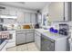 Cozy kitchen featuring ample gray cabinetry, modern appliances and tile flooring at 7016 2Nd N St, St Petersburg, FL 33702