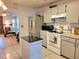 Bright kitchen with modern stainless steel refrigerator and white appliances at 7016 2Nd N St, St Petersburg, FL 33702