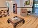 Comfortable living room featuring hardwood floors, a plush armchair, and stylish furniture at 7016 2Nd N St, St Petersburg, FL 33702