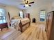 Spacious main bedroom features wood flooring and a ceiling fan at 7016 2Nd N St, St Petersburg, FL 33702