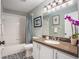 Updated bathroom with granite vanity, tub/shower, and decorative patterned tile floor at 7116 Colonial Lake Dr, Riverview, FL 33578