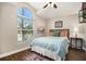 Cozy bedroom with vaulted ceiling, large window and wood look flooring at 7116 Colonial Lake Dr, Riverview, FL 33578