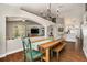 Open-concept dining room featuring wood floors, a chandelier, and views of the pool at 7116 Colonial Lake Dr, Riverview, FL 33578