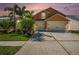 Charming two-story home with a three-car garage, lush landscaping, and a well-maintained driveway at 7116 Colonial Lake Dr, Riverview, FL 33578