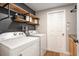 Functional laundry room features a washer, dryer, open shelving and plenty of space at 7116 Colonial Lake Dr, Riverview, FL 33578
