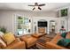 Cozy living room with leather furniture, ceiling fan, and sliding glass doors leading to the pool area at 7116 Colonial Lake Dr, Riverview, FL 33578