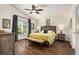 Spacious main bedroom featuring a ceiling fan, picture window, and wood-look floors at 7116 Colonial Lake Dr, Riverview, FL 33578