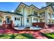 Expansive backyard featuring a brick fire pit, lush lawn, and elegant architectural details of the home at 802 Druid S Rd, Clearwater, FL 33756
