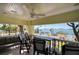 Relaxing covered balcony with comfortable seating, a ceiling fan, and panoramic views of the bay at 802 Druid S Rd, Clearwater, FL 33756