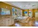 Luxurious primary bathroom boasts marble finishes, dual vanities and a large window offering stunning views at 802 Druid S Rd, Clearwater, FL 33756