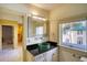 Modern bathroom featuring a unique glass sink, a stylish mirror and a window with a view at 802 Druid S Rd, Clearwater, FL 33756