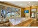 Bright primary bathroom features a jacuzzi style tub overlooking the bay and a wall mounted television at 802 Druid S Rd, Clearwater, FL 33756