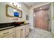 Elegant bathroom with marble floors, modern lighting, granite countertop and frameless glass shower at 802 Druid S Rd, Clearwater, FL 33756