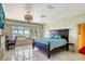 Cozy bedroom featuring a decorative fireplace, large windows, and scenic views at 802 Druid S Rd, Clearwater, FL 33756