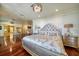 Bright primary bedroom featuring an upholstered bed, a chandelier and hardwood floors at 802 Druid S Rd, Clearwater, FL 33756