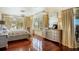 Serene primary bedroom with light tones, hardwood flooring, and views to the outside at 802 Druid S Rd, Clearwater, FL 33756