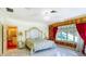 Luxury bedroom featuring a marble floor, large windows, and detailed wall coverings at 802 Druid S Rd, Clearwater, FL 33756