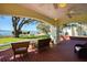 Relaxing covered patio featuring brick floors, ceiling fans, water view, and comfortable wicker furniture at 802 Druid S Rd, Clearwater, FL 33756