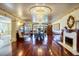 Formal dining room boasts hardwood floors, marble fireplace, and stunning chandelier lighting at 802 Druid S Rd, Clearwater, FL 33756