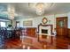 Spacious dining area showcases hardwood floors, fireplace, and elegant chandelier lighting at 802 Druid S Rd, Clearwater, FL 33756