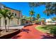 Angle view of a home showcasing porte cochere, circular brick driveway, and well-manicured landscaping at 802 Druid S Rd, Clearwater, FL 33756