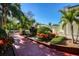 Exterior view of side yard showcasing the lush landscaping and architectural details of this home at 802 Druid S Rd, Clearwater, FL 33756