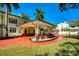 Exterior showcasing the porte cochere, brick driveway, and manicured lawn of this elegant residence at 802 Druid S Rd, Clearwater, FL 33756