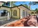 Charming exterior view showcasing the home's architecture, statues, lush landscaping, and brick walkway at 802 Druid S Rd, Clearwater, FL 33756