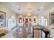 Grand foyer with marble floors, crystal chandeliers, and arched windows, offering a luxurious entry at 802 Druid S Rd, Clearwater, FL 33756